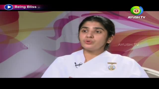 A woman in a white uniform is speaking, her mouth moving as if mid-sentence. The Ayush TV logo is visible in the corner, and the backdrop is a soft, abstract pattern.
