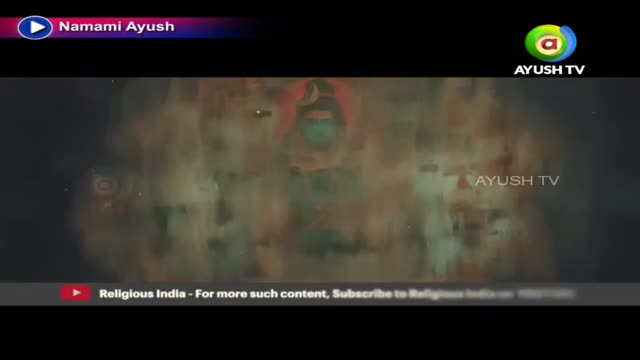The Ayush TV logo sits in the corner, while a blurred image of a deity appears center screen. Below, a small banner encourages viewers to subscribe to Religious India.
The Ayush TV logo sits in the corner, while a blurred image of a deity appears center screen. Below, a small banner encourages viewers to subscribe to Religious India.