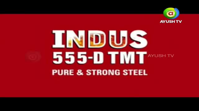 The screen displays bold white text announcing "INDUS 555-D TMT" against a vibrant red background. Below that, "PURE & STRONG STEEL" is written in smaller white lettering. The Ayush TV logo appears in the upper right corner. The screen displays bold white text announcing "INDUS 555-D TMT" against a vibrant red background. Below that, "PURE & STRONG STEEL" is written in smaller white lettering. The Ayush TV logo appears in the upper right corner.