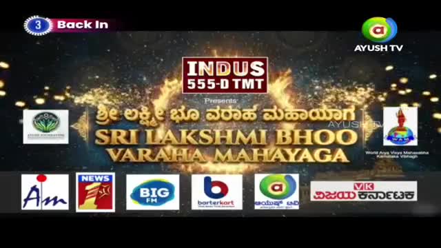 The Ayush TV logo glows above the golden text "SRI LAKSHMI BHOO VARAHA MAHAYAGA." Below, logos for Indus 555-D TMT and various Indian media outlets flash on screen.