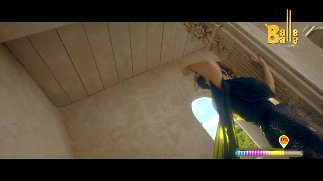 A woman in a dark, sparkly dress reaches up, her arm arched towards the ornate ceiling. The "Balle Balle" logo sits in the corner, and a progress bar hovers near her.
