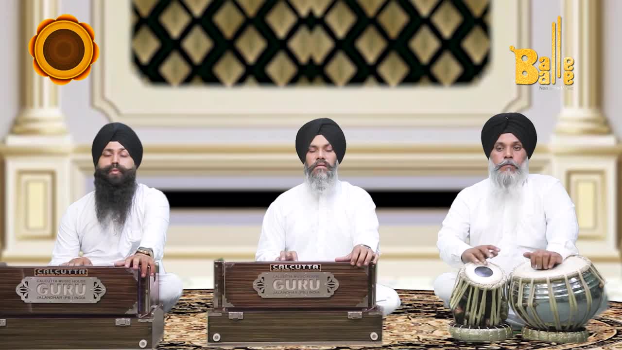 Three men in white are seated, each focused on their instrument. The one on the right taps the tabla drums, while the other two play harmoniums, all set against a backdrop with a logo that says "Balle Balle."
