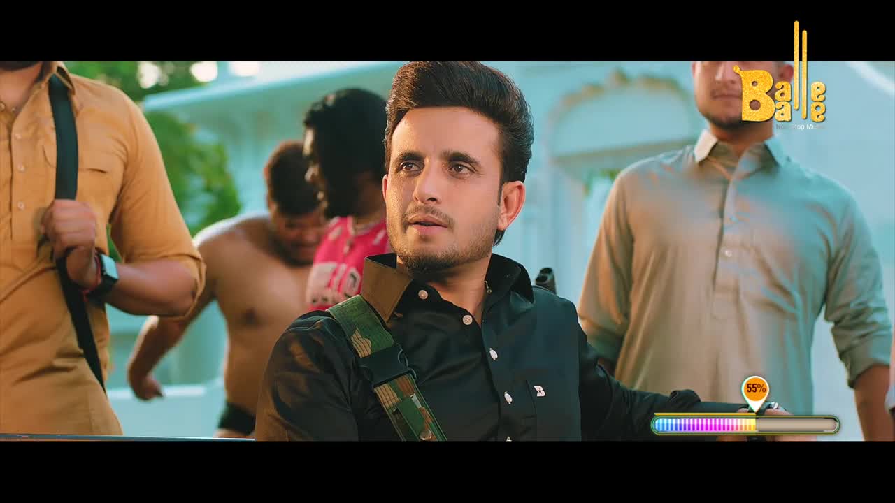 The man in the black shirt looks up, flanked by others, with a camouflaged strap over his shoulder. A progress bar hovers at the bottom, and the "Balle Balle" logo is visible in the top right corner.
