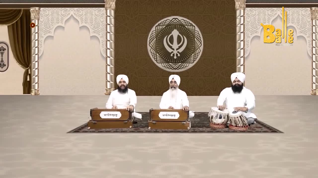 Three men in white are seated on the floor, playing instruments. The man on the right is drumming on a pair of tabla, while the other two play harmoniums.
