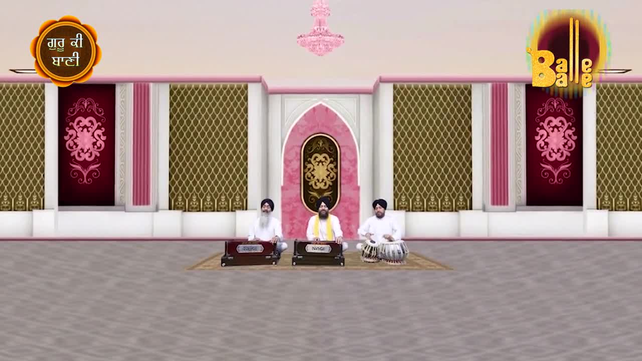 Three men, seated on the floor, play instruments in front of a decorative backdrop. The central figure wears a yellow shawl, while the others accompany him with a harmonium and tabla.

