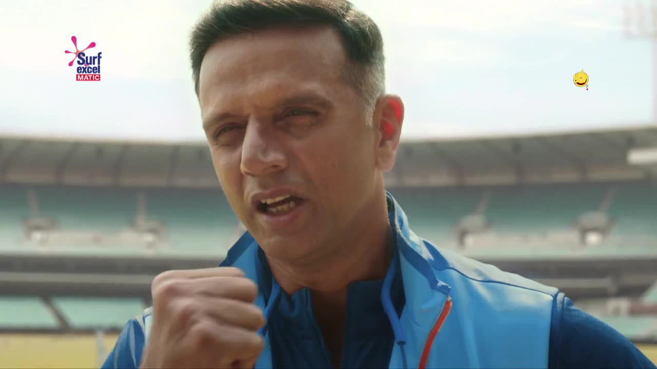 He's in the stadium, wearing the blue and orange of the Indian team. His fist is clenched, and he's shouting, ready to celebrate a win, Balle Balle!
