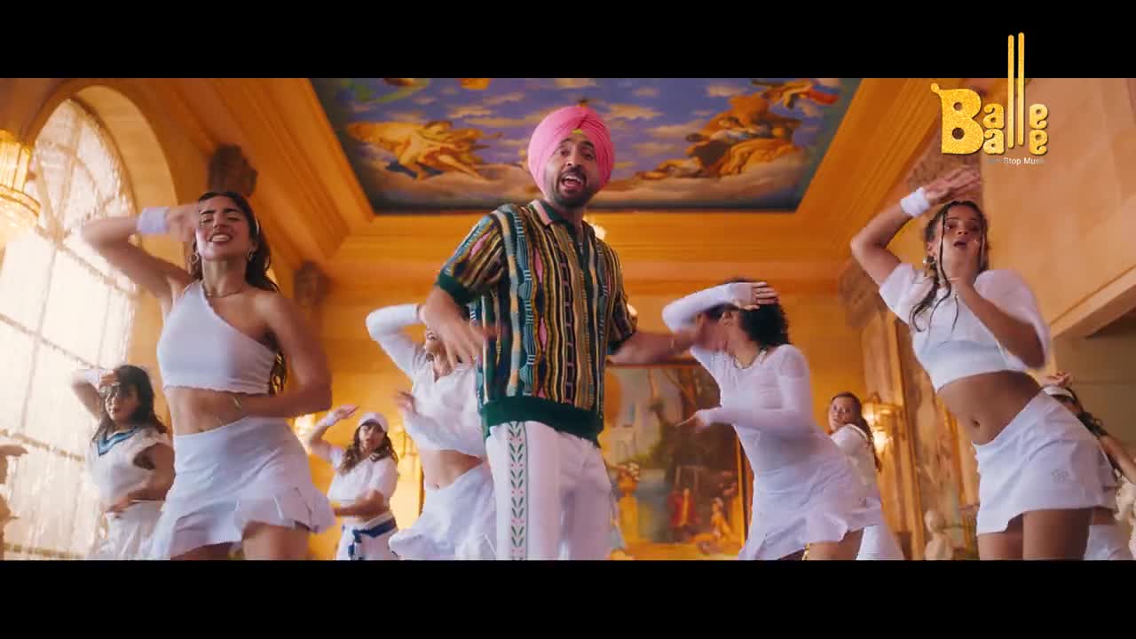 A man in a pink turban and colorful sweater dances at the center, surrounded by women in white outfits. They're all moving their arms and bodies in sync, with a "Balle Balle" logo in the corner.
A man in a pink turban and colorful sweater dances at the center, surrounded by women in white outfits. They're all moving their arms and bodies in sync, with a "Balle Balle" logo in the corner.