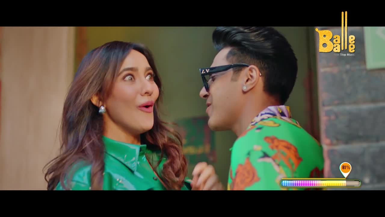 The woman in the green jacket stares wide-eyed, her mouth agape. A man in sunglasses leans in close, as if about to say something, with the "Balle Balle" logo in the corner.
The woman in the green jacket stares wide-eyed, her mouth agape. A man in sunglasses leans in close, as if about to say something, with the "Balle Balle" logo in the corner.