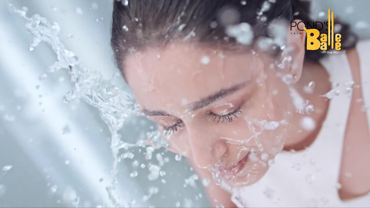 Water sprays up and over a woman's face, droplets clinging to her closed eyelashes. The clear liquid cascades down, creating a refreshing effect, a moment of Balle Balle beauty.
Water sprays up and over a woman's face, droplets clinging to her closed eyelashes. The clear liquid cascades down, creating a refreshing effect, a moment of Balle Balle beauty.