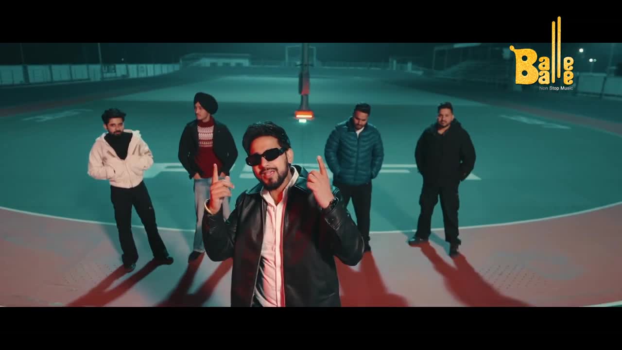 A man in sunglasses and a leather jacket gestures with both hands, while four others stand behind him. The logo for Balle Balle music is in the corner.
