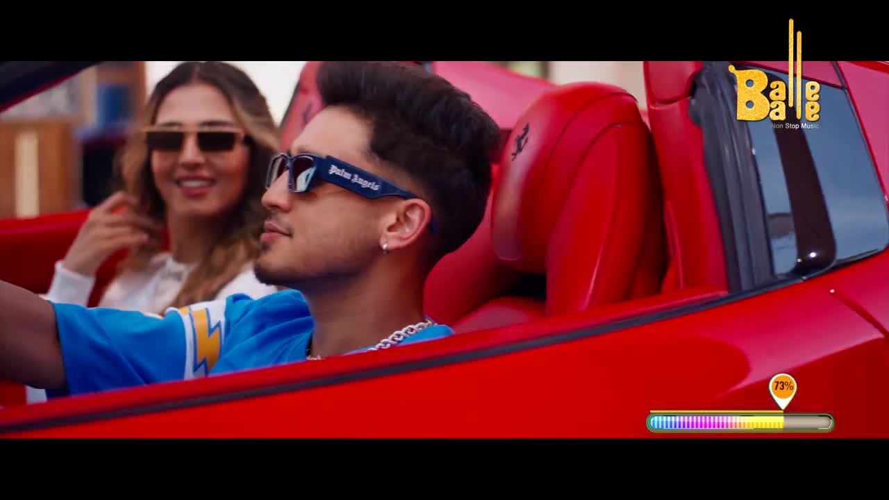 A man in sunglasses drives a red convertible, his passenger smiling beside him. The Balle Balle logo sits in the corner, and a progress bar indicates the song is well underway.
