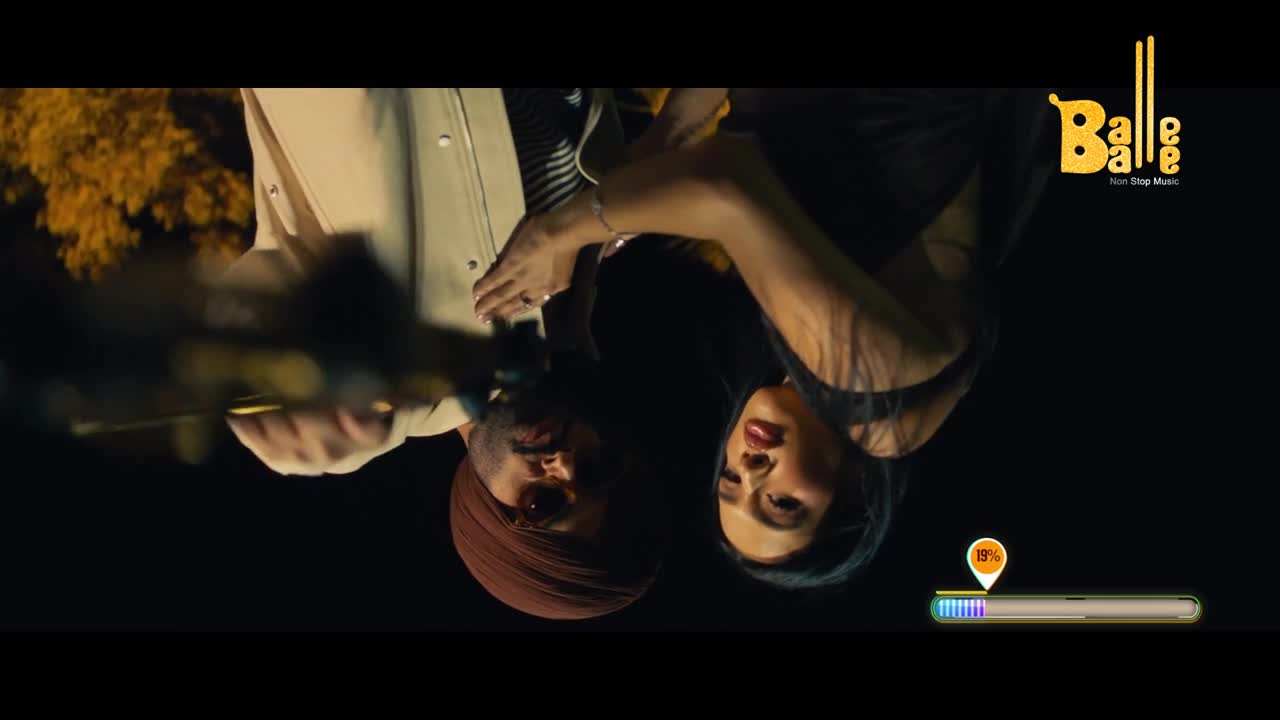A man in a turban and a woman lean towards each other, their faces close. The Balle Balle logo appears in the corner, hinting at Punjabi music.