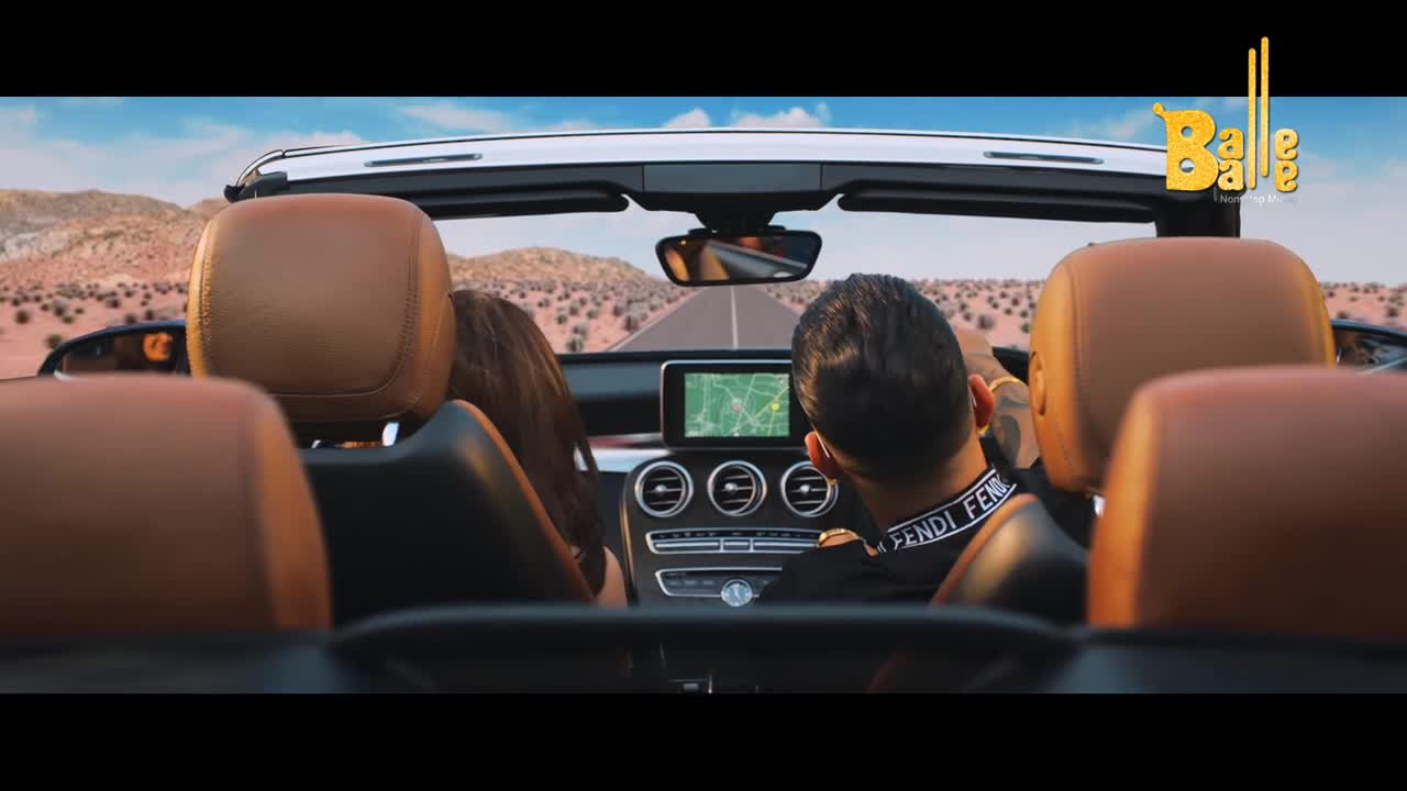 The convertible speeds down a long, straight road through a desert landscape. Inside, a couple enjoys the ride, the driver focused on the GPS.