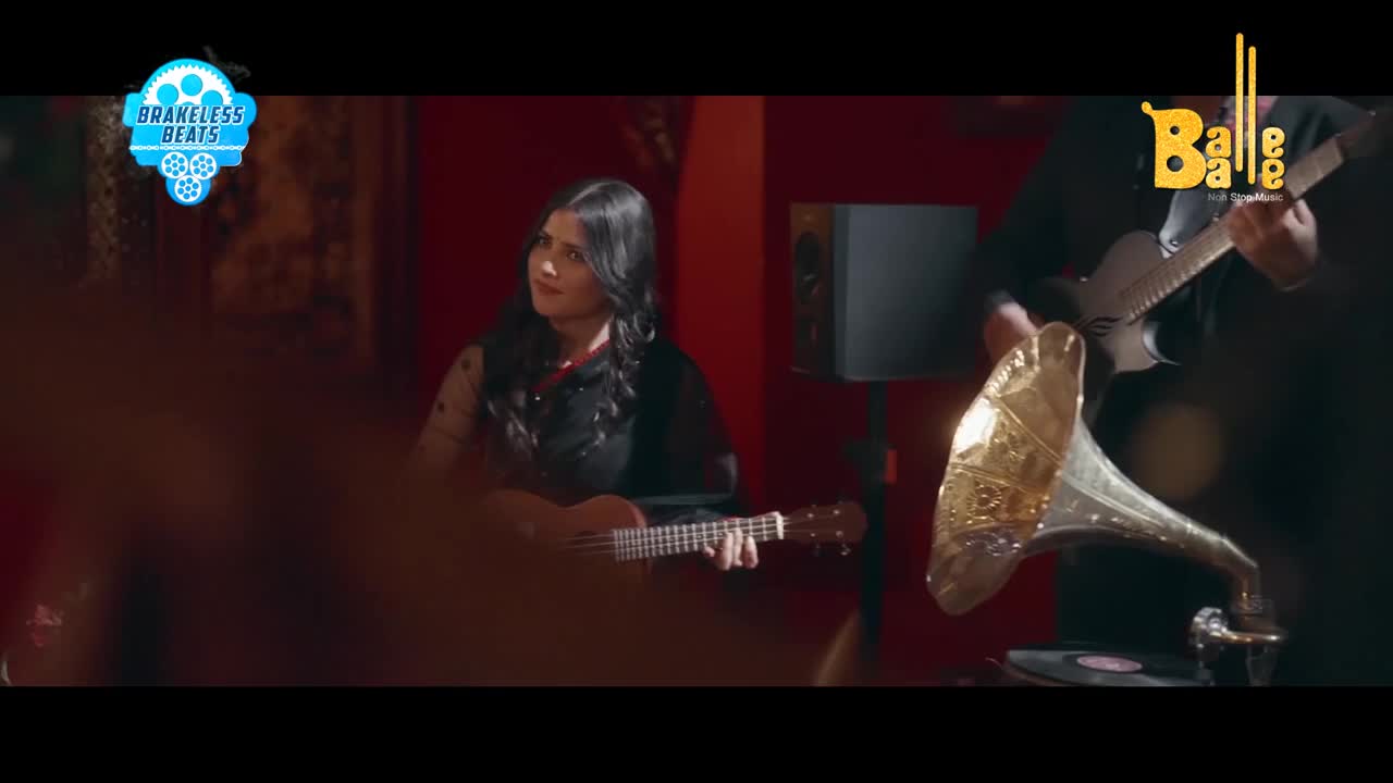 A woman strums a ukulele, her gaze directed upward. Beside her, a man plays an electric guitar, his focus on the instrument, while a vintage gramophone sits nearby.