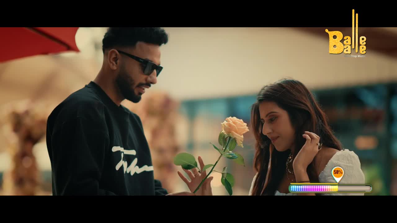 A man in sunglasses offers a pale yellow rose to a woman. The Balle Balle logo appears in the upper right corner.