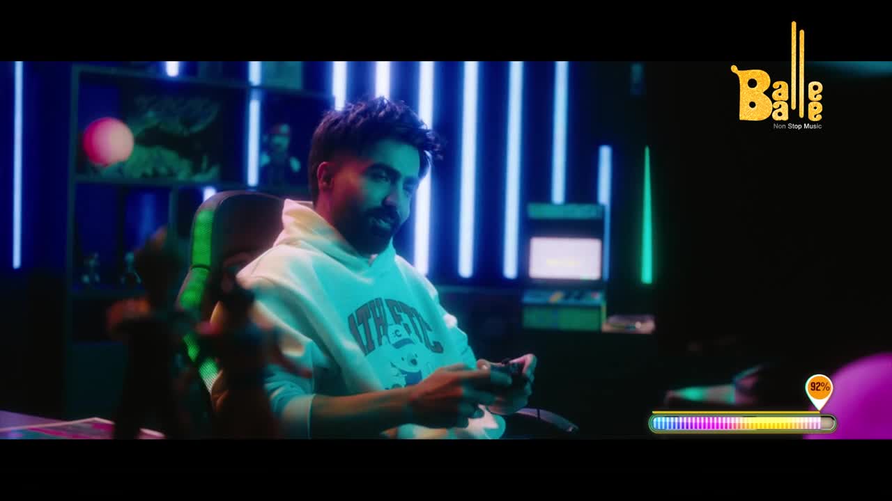 A young man in a white hoodie grips a video game controller, his eyes fixed on the screen. Neon lights glow behind him, casting a vibrant blue and green hue across the room, a scene that feels right at home in a modern Indian setup.