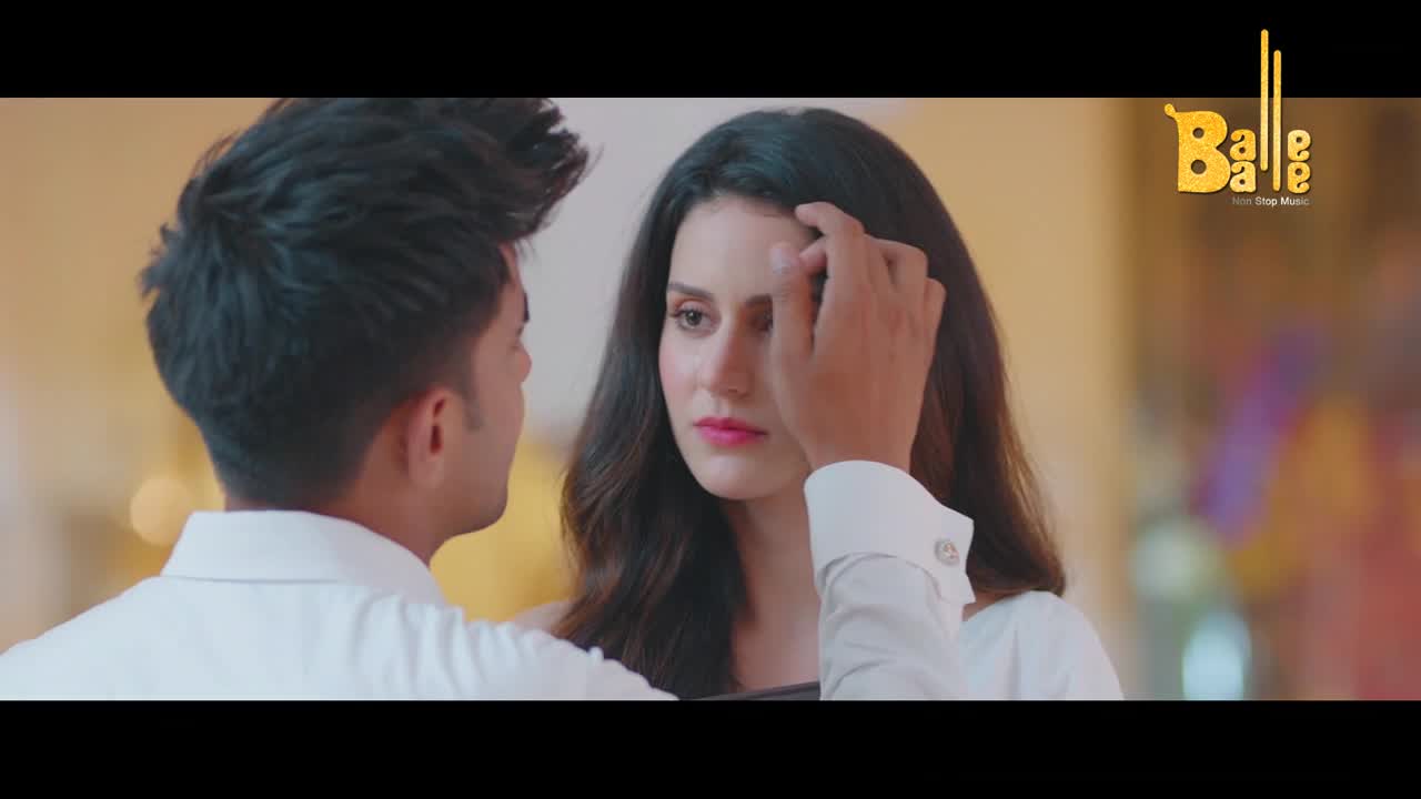 A man's hand gently brushes a strand of hair from a woman's forehead. Their eyes meet, a silent conversation passing between them.