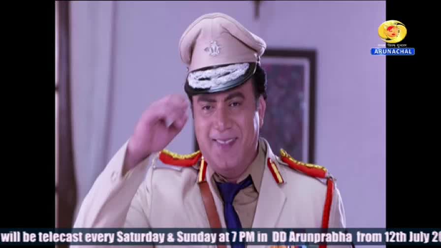 A man in a police uniform, complete with a cap and epaulettes, smiles and raises his hand in a salute. The DD Arunprabha logo is visible in the corner, and the bottom of the screen indicates the show will be telecast on Saturdays and Sundays.
