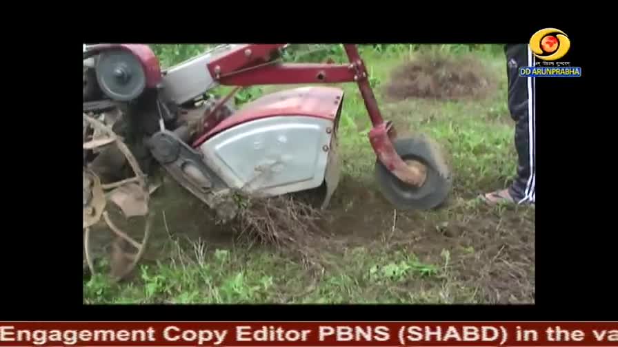 A small, red tiller is churning through the muddy ground, kicking up clumps of earth and grass. A person in black pants stands nearby, seemingly guiding the machine.
A small, red tiller is churning through the muddy ground, kicking up clumps of earth and grass. A person in black pants stands nearby, seemingly guiding the machine.