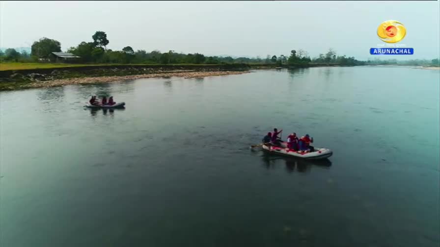 Two inflatable rafts glide down a wide, calm river. People in the rafts, some wearing red, paddle gently. Two inflatable rafts glide down a wide, calm river. People in the rafts, some wearing red, paddle gently.