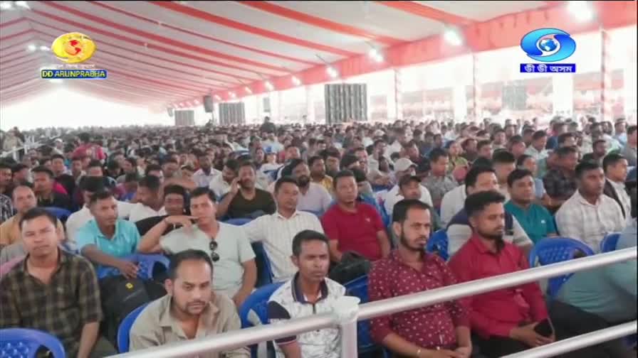 A vast crowd sits attentively under a striped tent, their faces turned towards an unseen stage. The DD Arun Prabha logo is visible in the upper left corner, indicating this is a broadcast from India.