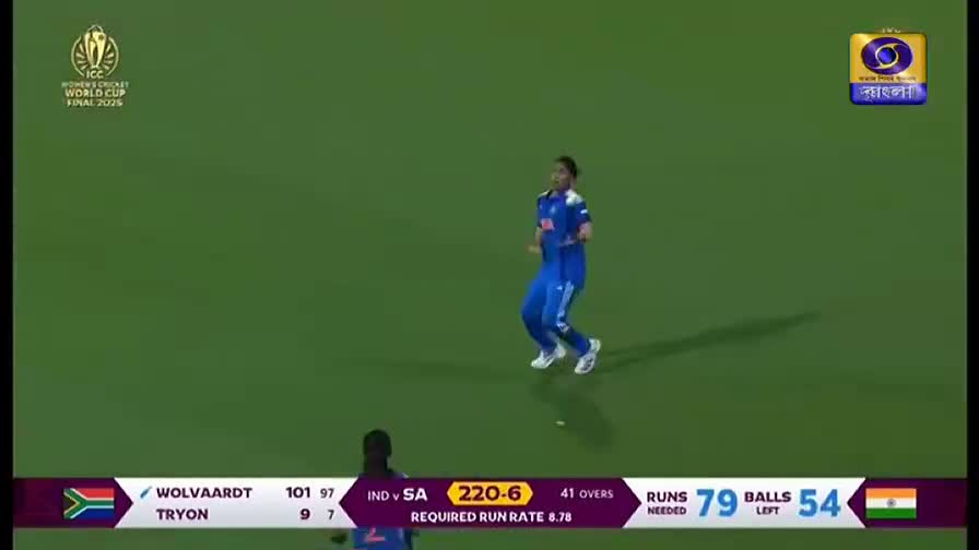 An Indian player in blue leaps across the green field, with the DD Bangla logo visible in the corner. The scoreboard shows India needs 79 runs to win.
An Indian player in blue leaps across the green field, with the DD Bangla logo visible in the corner. The scoreboard shows India needs 79 runs to win.