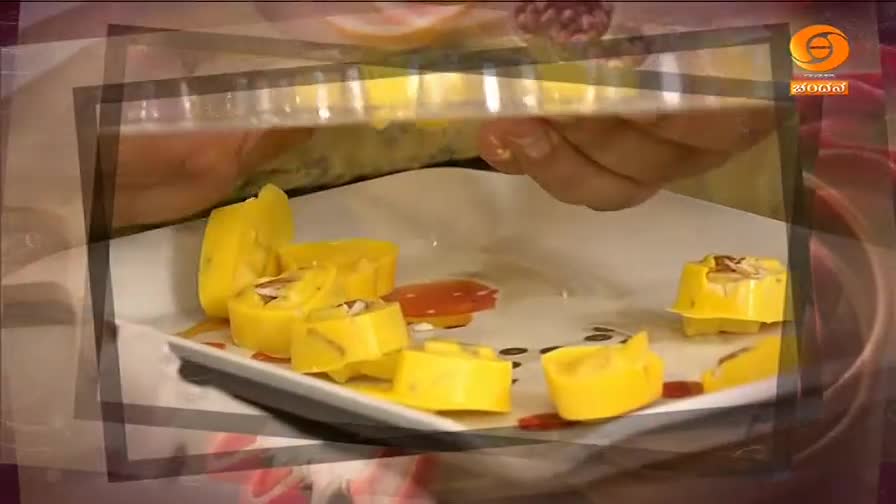 A hand carefully places bright yellow, sweet treats onto a white plate. These are likely a dessert being prepared for a program on DD Chandana.