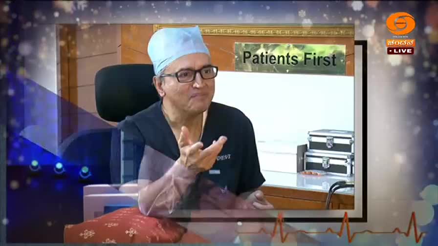 A doctor in a light blue surgical cap speaks animatedly, gesturing with his hands. A sign behind him reads "Patients First," and the DD Chandana logo is visible in the corner.