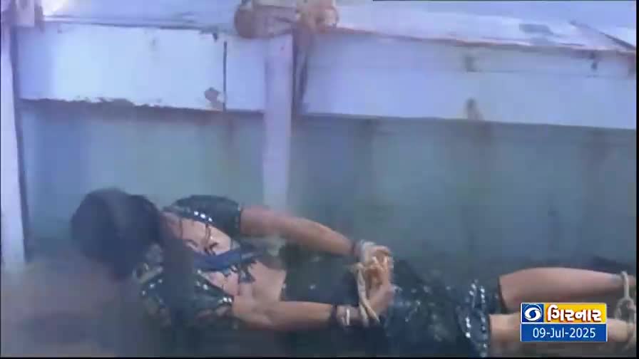 A woman lies on the ground, her hands tied in front of her. The scene is being broadcast on DD Girnar, with the date July 9, 2025, visible in the corner.
