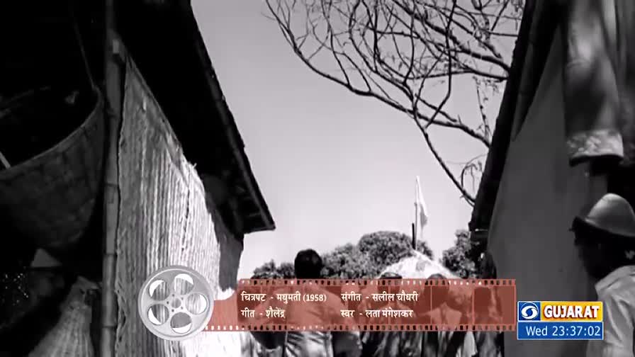 The camera looks up a narrow alleyway, the sky visible between the buildings and tree branches. A small flag waves in the distance.
