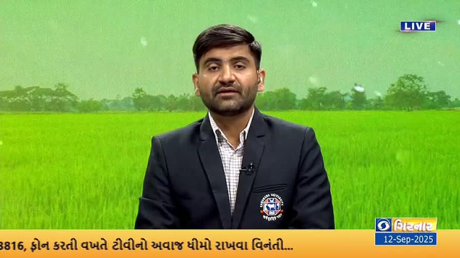 A man in a dark blazer speaks directly to the camera, the DD Girnar logo visible in the corner. Behind him, a green field stretches out, suggesting a backdrop of the countryside.
