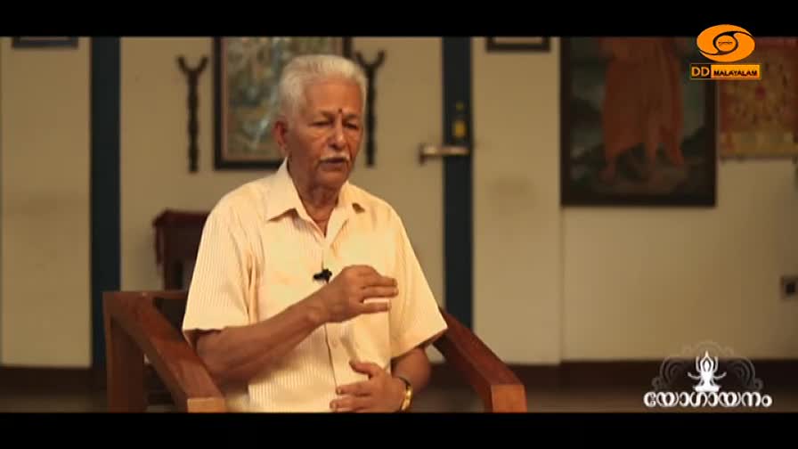 An older gentleman with white hair and a mustache speaks animatedly, gesturing with his hands. He wears a light-colored, striped shirt, and a microphone is clipped to his collar. An older gentleman with white hair and a mustache speaks animatedly, gesturing with his hands. He wears a light-colored, striped shirt, and a microphone is clipped to his collar.