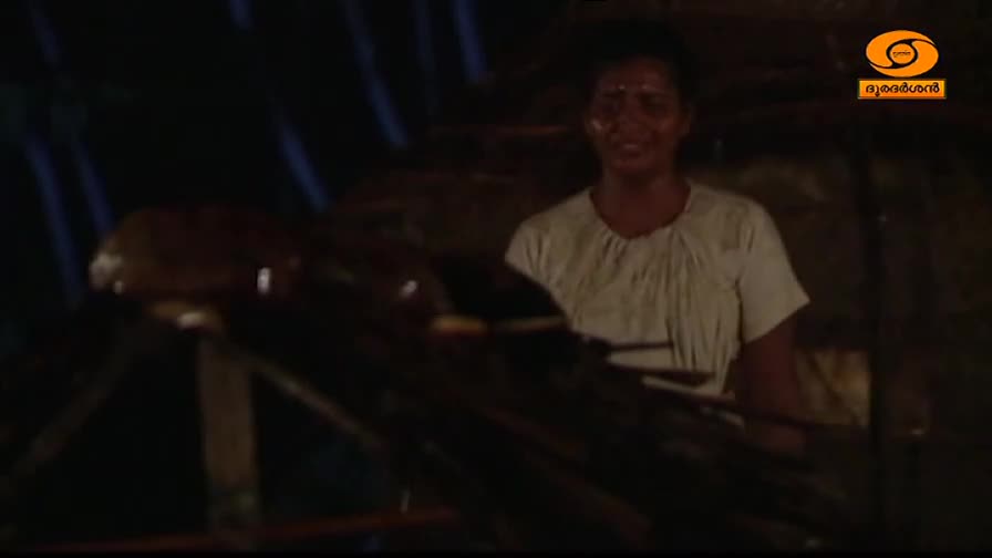 A woman in a white garment works at a loom, her face etched with strain. The dim light catches the rough texture of the wood and fabric around her.