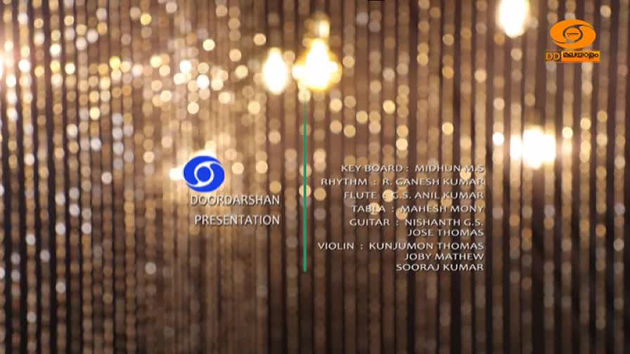 A DoorDarshan Presentation scrolls past, listing musicians. The DD Malayalam logo glows on the right.
