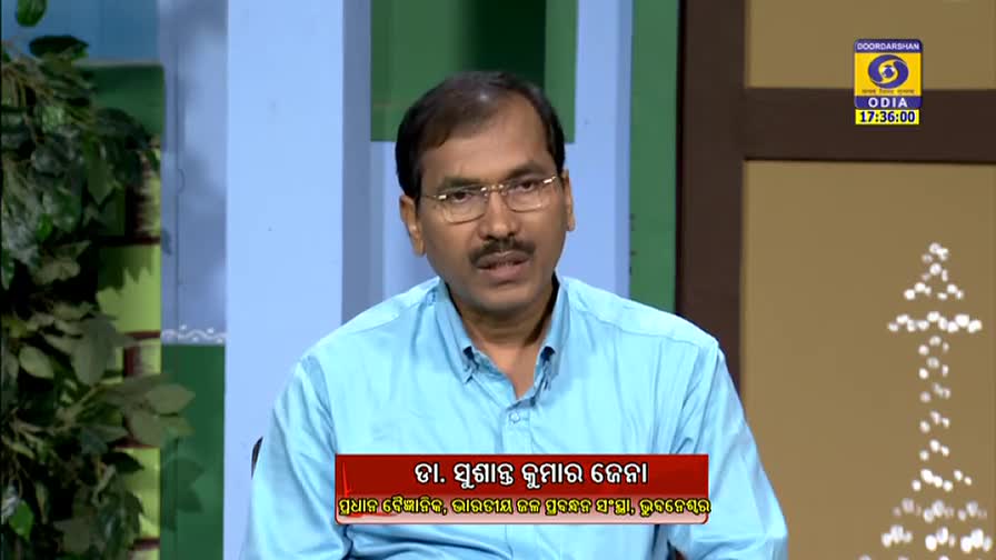 A man in a light blue shirt speaks directly to the camera, his expression serious. Below him, a red banner identifies him as Dr. Sushant Kumar Jena, a scientist from India.
