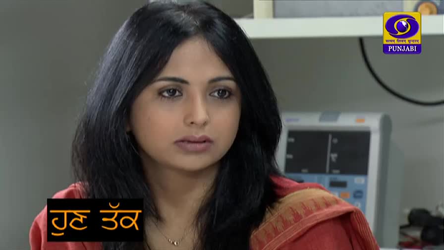 A woman with dark hair and a red shawl stares directly ahead, a serious expression on her face. The DD Punjabi logo and a graphic in Punjabi are visible in the corner of the screen.
