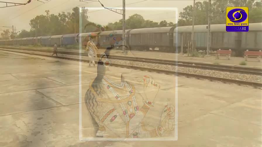 A train, its carriages a faded blue, sits at the station, while two people walk along the platform. The DD Punjabi logo sits in the corner, and an overlaid image of a woman is visible.
