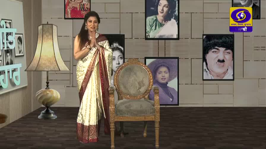 A woman in a cream and maroon sari stands with her hands pressed together, greeting the audience. Behind her, framed portraits of actors and the DD Punjabi logo adorn the wall.