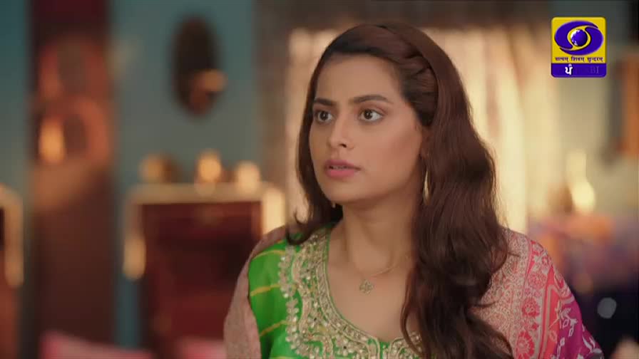 A young woman with a braided hairstyle and a bright green and pink embroidered outfit looks off to the side with a concerned expression. The DD Punjabi logo is visible in the upper right corner.