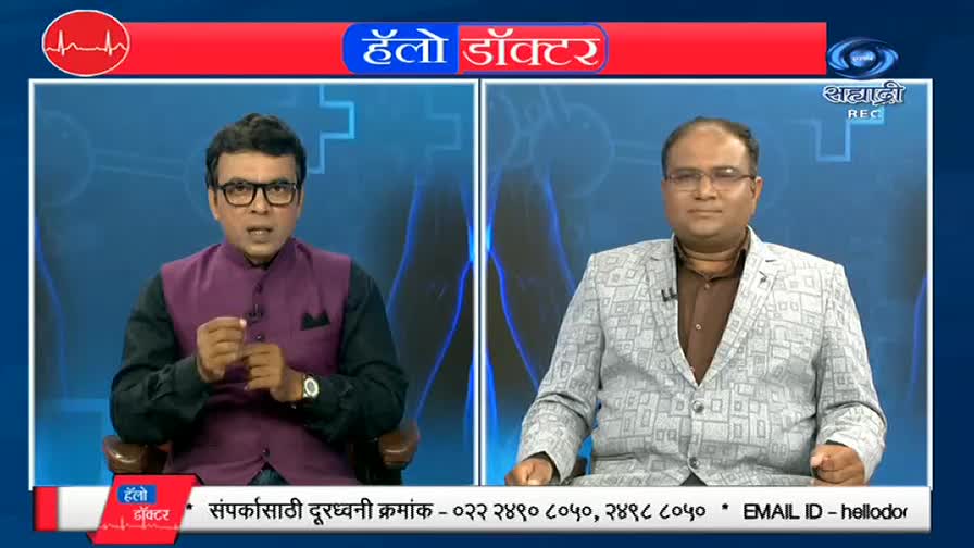 On DD Sahyadri, two men in suits sit side-by-side, the one on the left gesturing as he speaks. The "Hello Doctor" logo is visible, and a phone number scrolls along the bottom.
