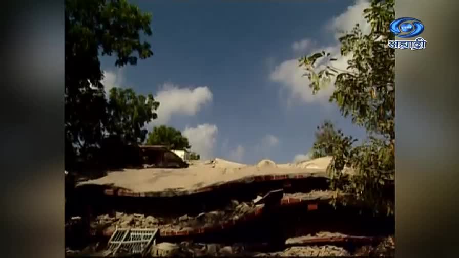 A collapsed roof, with red bricks visible, is framed by trees against a bright sky. The DD Sahyadri logo is in the top right corner.
