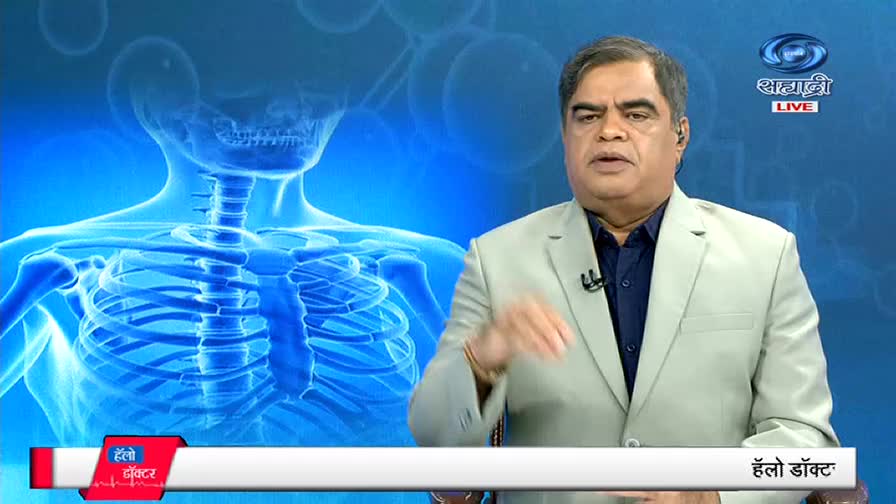 The man in the light jacket gestures with his hands, speaking directly to the camera on DD Sahyadri's "Hello Doctor" program. Behind him, a blue graphic of a human skeleton is visible.
