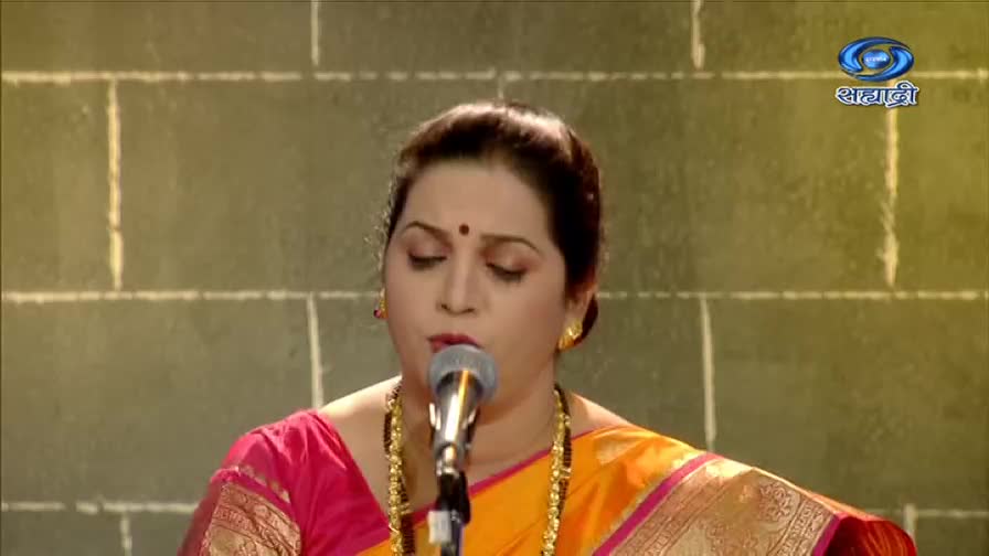 A woman in a sari sings into a microphone, her eyes closed. The DD Sahyadri logo sits in the corner, a familiar sight from Indian television.
