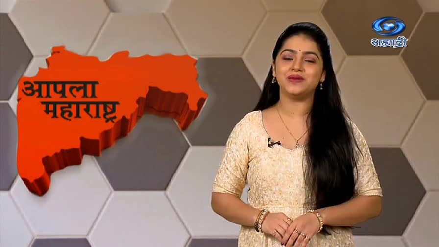 A woman in a cream-colored dress smiles as she speaks on the DD Sahyadri set. Behind her, a 3D map of Maharashtra glows next to the channel's logo.
