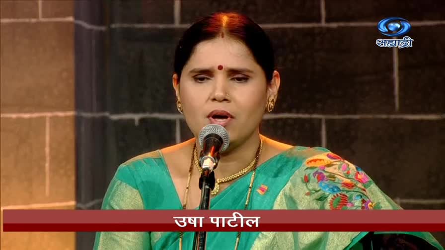 Usha Patil sings into a microphone, her face illuminated by the stage lights. The DD Sahyadri logo sits in the corner, and her name is displayed in Marathi below.
