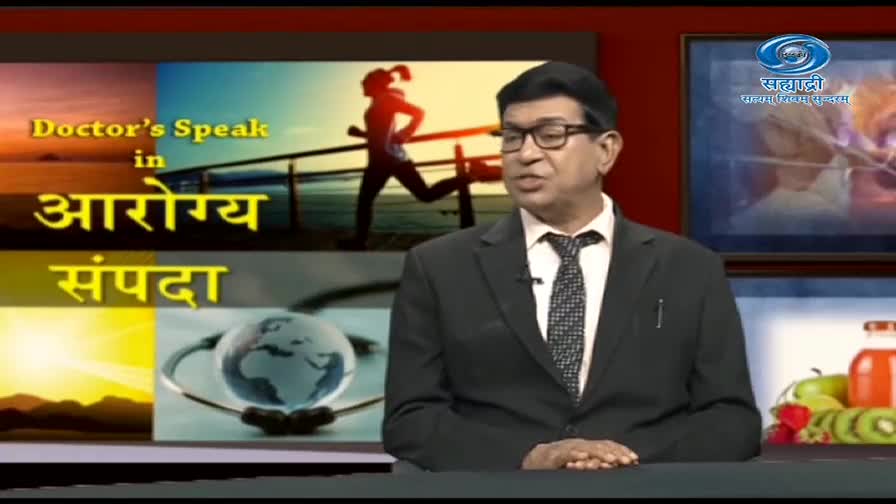 A man in a suit speaks, framed by the "Doctor's Speak" title card from DD Sahyadri. Behind him, a runner is silhouetted against a beach scene.
