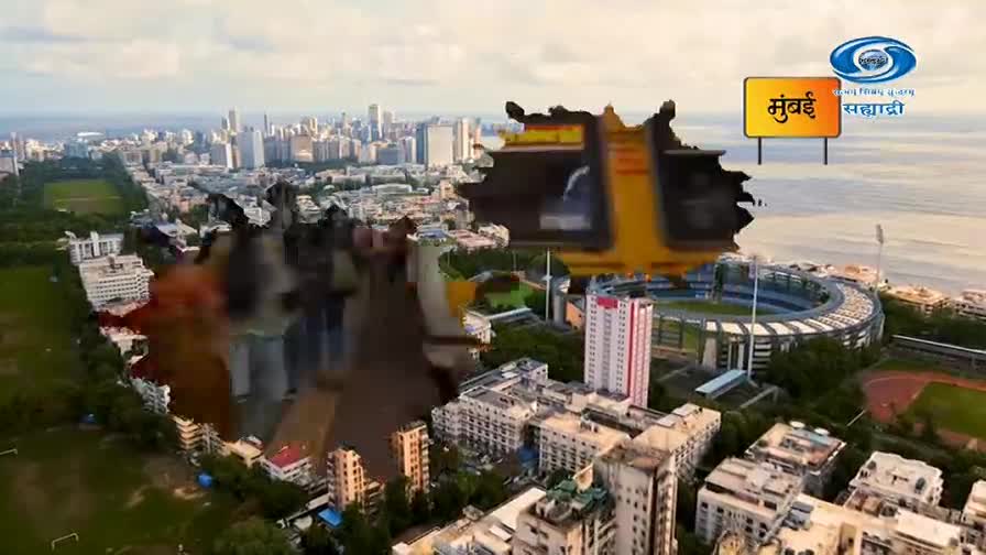 A yellow auto-rickshaw is driving through a bustling city street. The DD Sahyadri logo is visible in the sky above a stadium.