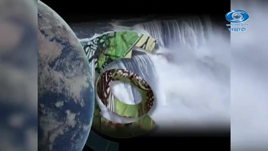 A large, blue and white Earth hangs to the left, partially obscuring a powerful waterfall. Rings of green foliage and white water tumble down, with the DD Sahyadri logo visible on the right. A large, blue and white Earth hangs to the left, partially obscuring a powerful waterfall. Rings of green foliage and white water tumble down, with the DD Sahyadri logo visible on the right.