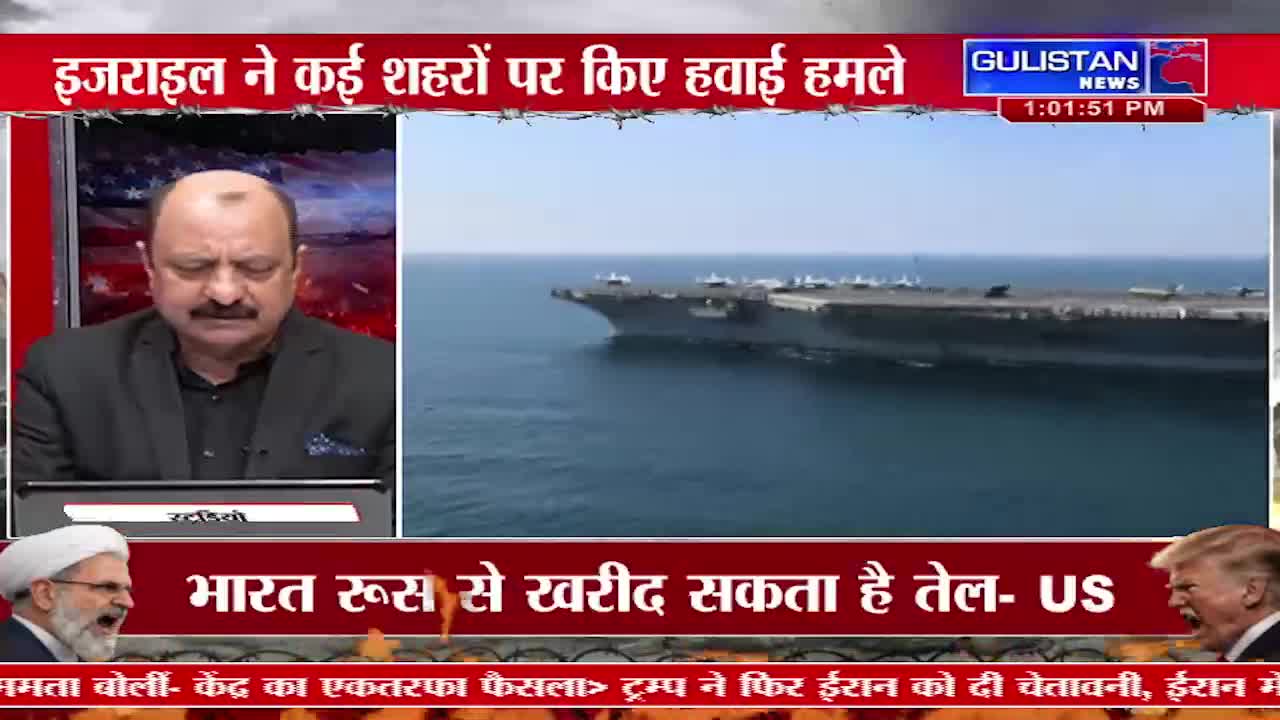 A massive aircraft carrier cuts through the deep blue water. On the screen, a man in a suit speaks, his expression serious.