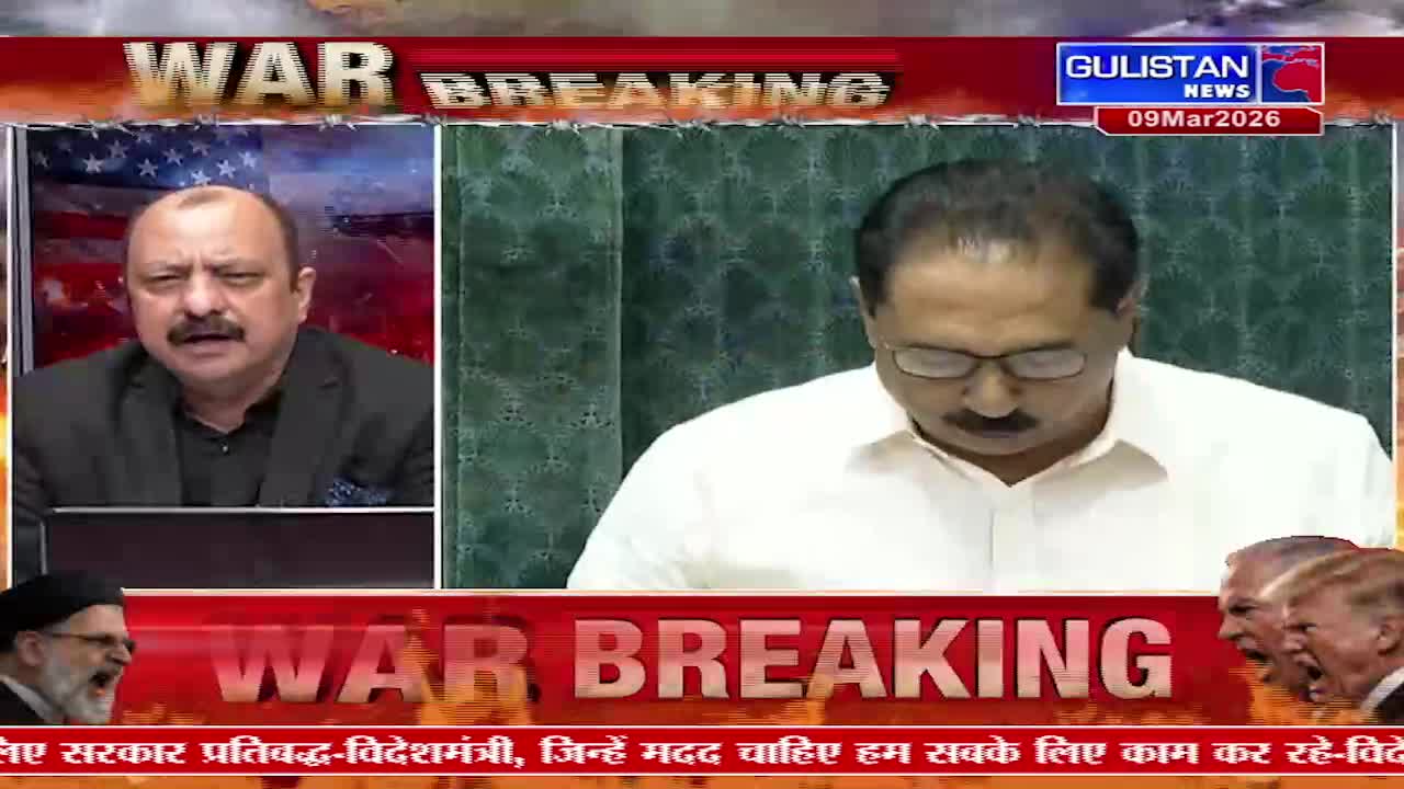 A man in a black jacket speaks animatedly, his mustache prominent. To his right, another man in a white shirt looks down, his glasses reflecting the light. The Gulistan News logo flashes in the corner, indicating a breaking report.